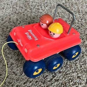 Vintage Fisher-Price toddler bouncing buggy with little people figures built-in.